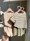 Adorable baby boy in a beige and green striped summer outfit set featuring a textured short sleeve top and matching shorts Perfect for warm weather