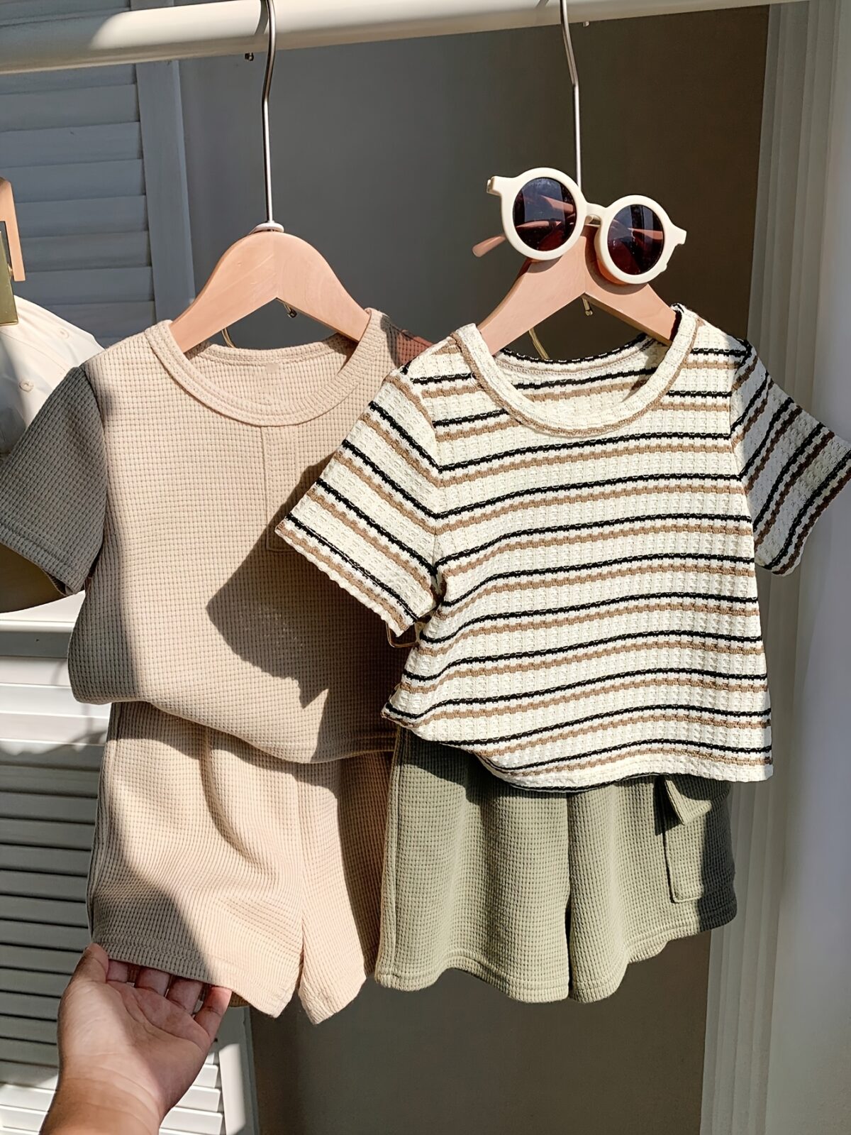 Adorable baby boy in a beige and green striped summer outfit set featuring a textured short sleeve top and matching shorts Perfect for warm weather