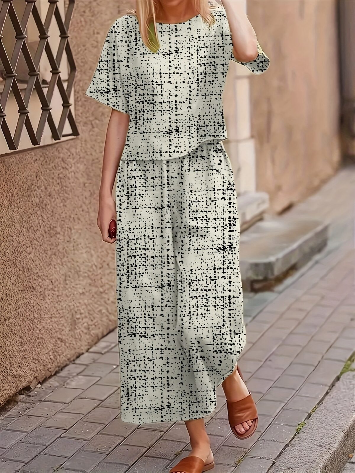 Model wearing the Newness Dubai Nights Geometric Print Set a two piece outfit with a striking geometric pattern