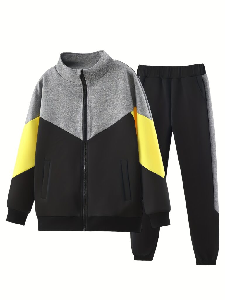 Stylish boy wearing a Newness Comfort Champ color block tracksuit, featuring a zip-up jacket and joggers in fall colors. Perfect for playtime or casual outings.