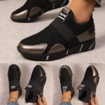 Womens black slip on sneakers with golden accents showcasing the breathable knit upper and flexible sole