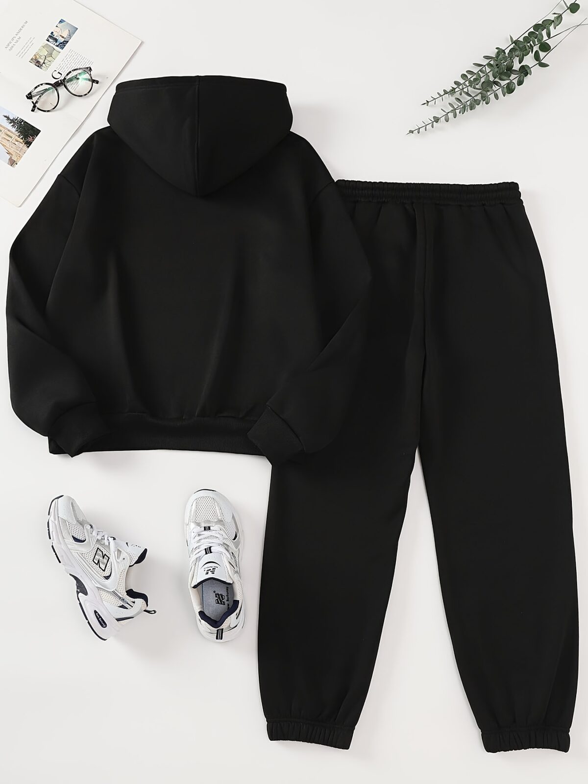 The Newness Minimalist Letter Print Two Piece Set in a cozy autumnal setting A stylish model wears the matching top and pants showcasing the comfortable fit and minimalist letter print Perfect for lounging or a casual day out
