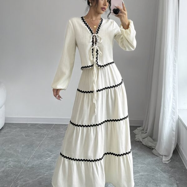 Effortlessly chic Casablanca Tiered Maxi Skirt Set from Newness. Model showcasing the complete set, featuring a flowing maxi skirt with tiers and a coordinating top.