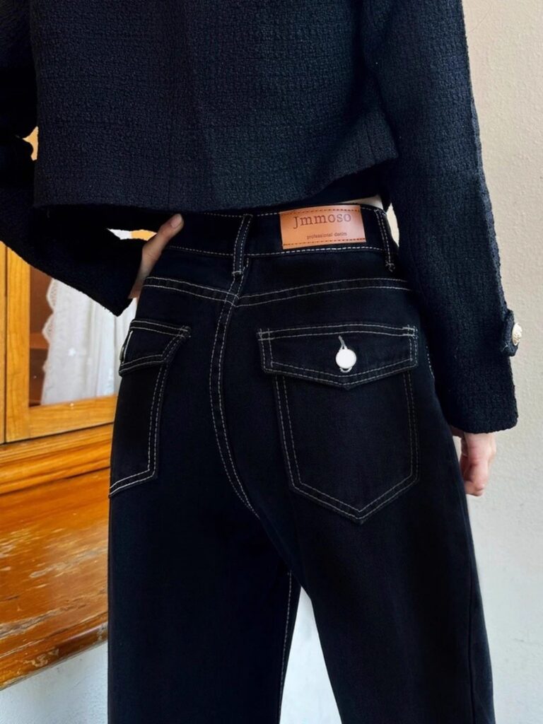 Newness Midnight Hour Black High-Waisted Jeans: A model showcasing the flattering fit and chic style of the jeans.