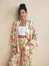 Model wearing the Newness Summer Escape Tropical Print Suit a vibrant and chic outfit perfect for beach vacations and beyond