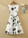 Model wearing the Newness Summer Solstice Floral Print Dress a chic and flattering midi dress with a retro inspired floral print perfect for summer