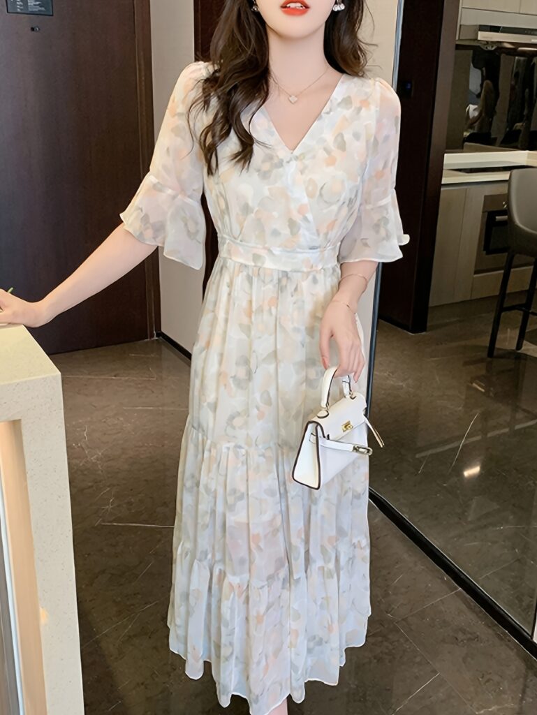 Effortlessly chic Newness Amelie floral midi dress, perfect for spring, featuring a flattering fit and delicate floral print.