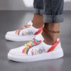 Newness Rainbow Burst Sneakers Chic comfort redefined A pair of vibrant rainbow striped sneakers showcasing their stylish design and comfortable fit