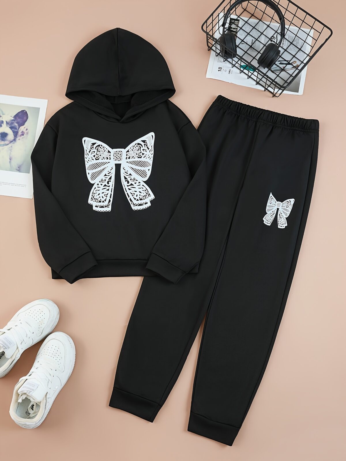 Adorable girl wearing a playful spring hues hooded sports suit featuring a charming cartoon print Perfect for spring adventures
