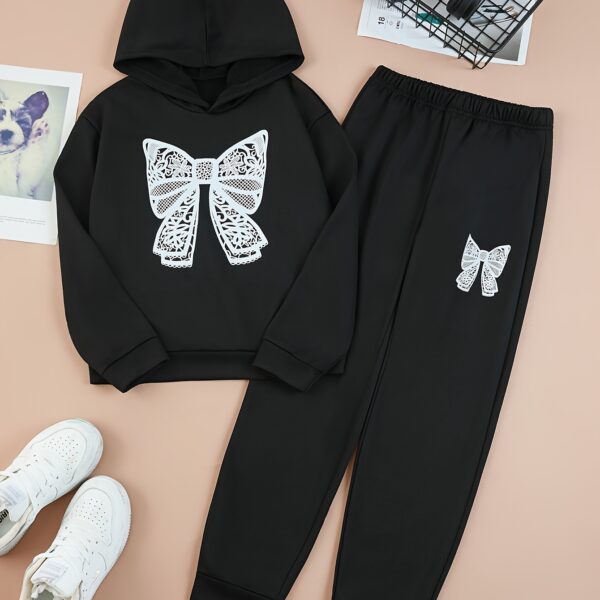 Adorable girl wearing a playful spring hues hooded sports suit featuring a charming cartoon print Perfect for spring adventures