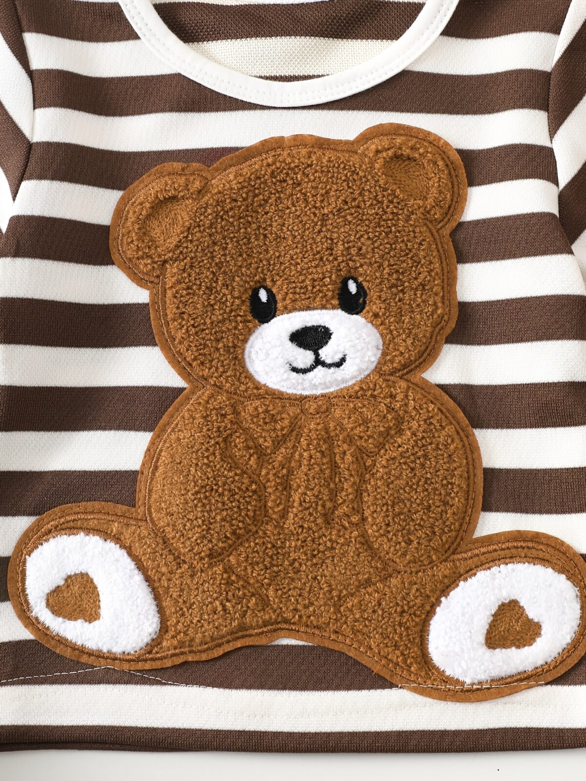 Adorable baby boy wearing Newness Cozy Cub Two Piece Set featuring a striped top with bear embroidery and matching shorts Perfect for spring and summer