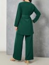 Sand colored polyester two piece pant set featuring a relaxed top and wide leg pants Model poses effortlessly chic