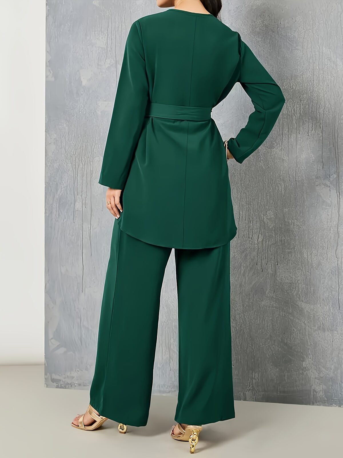 Sand colored polyester two piece pant set featuring a relaxed top and wide leg pants Model poses effortlessly chic