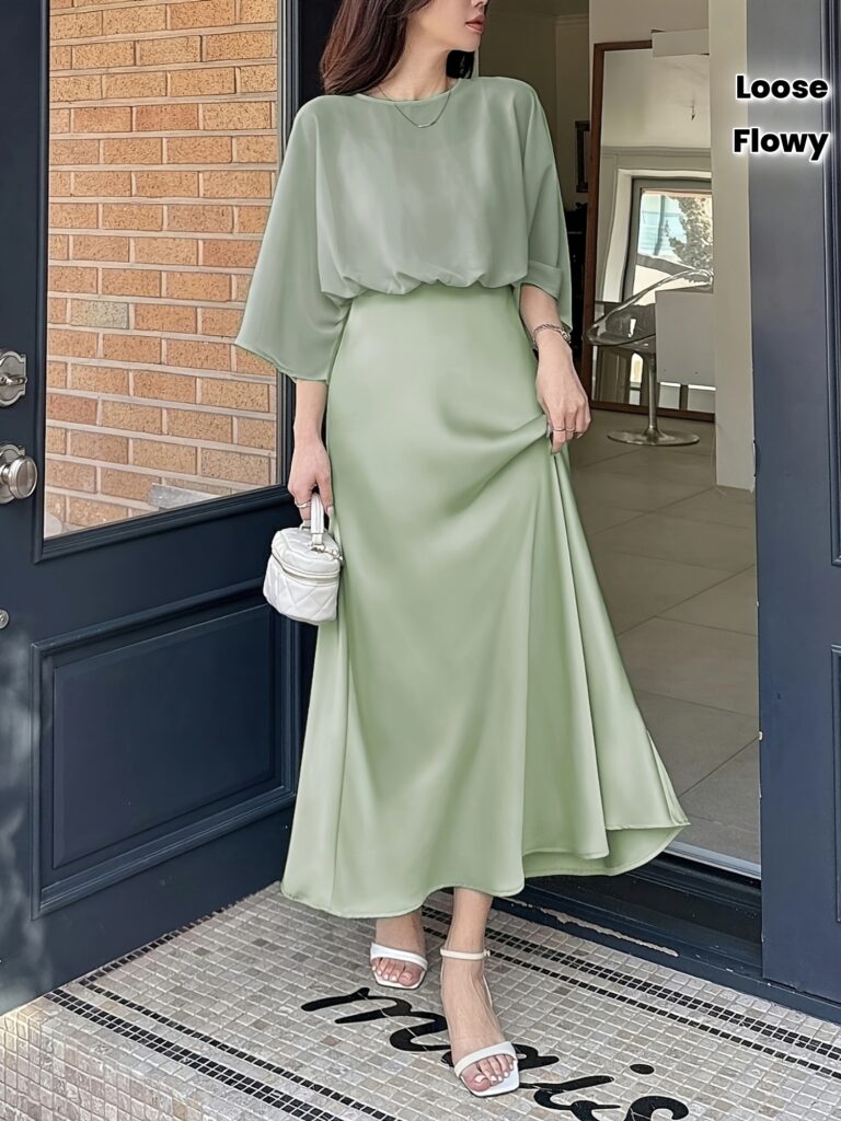 Effortlessly chic light green loose top with flowy dress, perfect for summer. Model wears the dress, showcasing its breezy fabric and flattering silhouette.