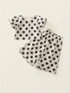 Adorable girls polka dot suit perfect for summer made from 100 soft cotton The suit features a mention specific details like sleeveless top and shorts or skirt design