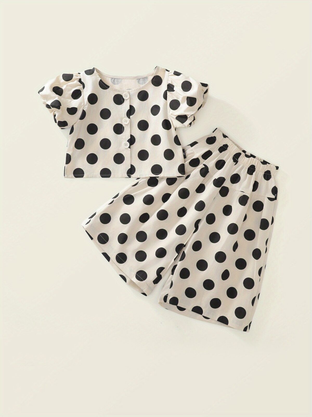 Adorable girls polka dot suit perfect for summer made from 100 soft cotton The suit features a mention specific details like sleeveless top and shorts or skirt design