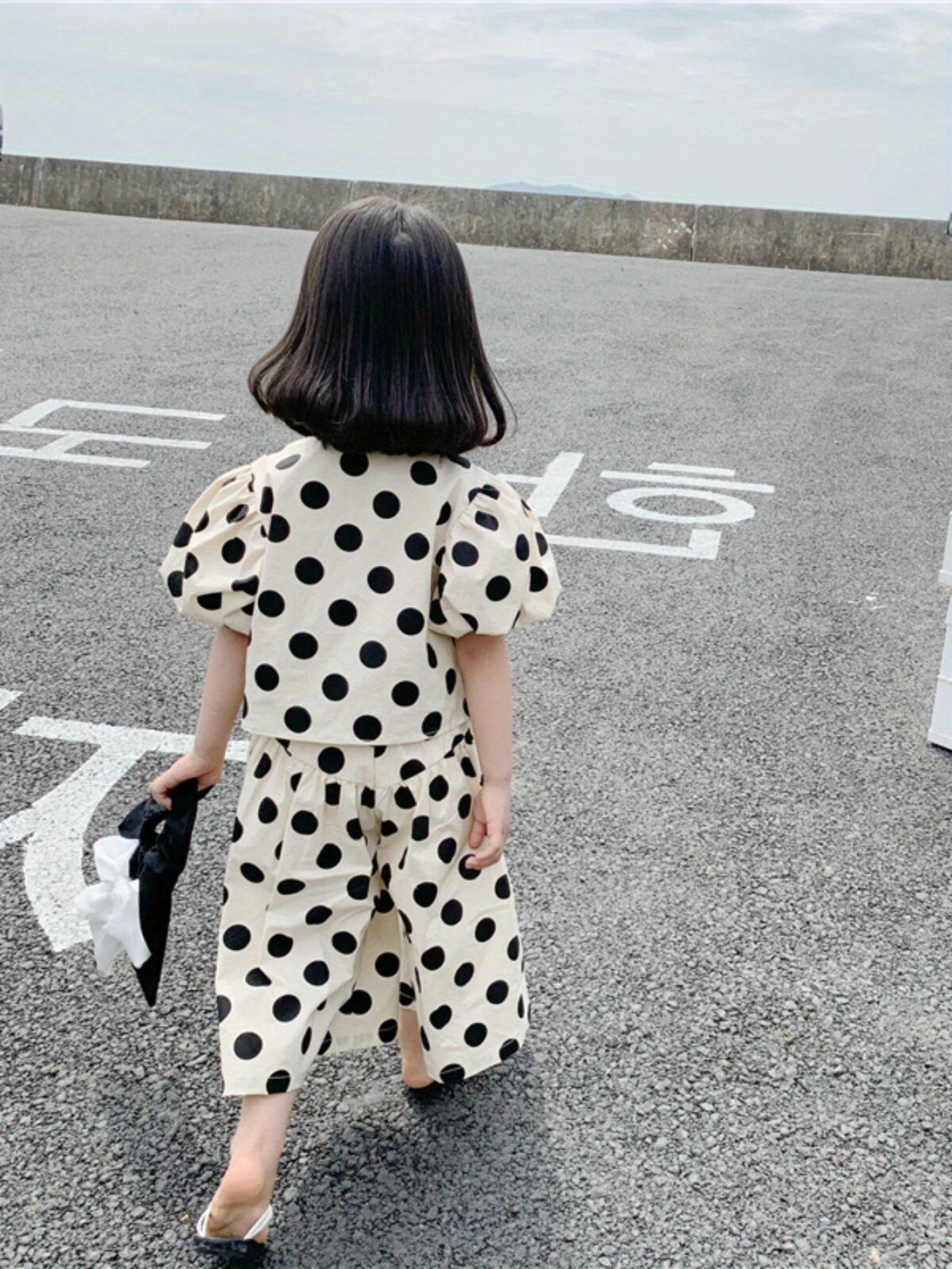 Adorable girls polka dot suit perfect for summer made from 100 soft cotton The suit features a mention specific details like sleeveless top and shorts or skirt design