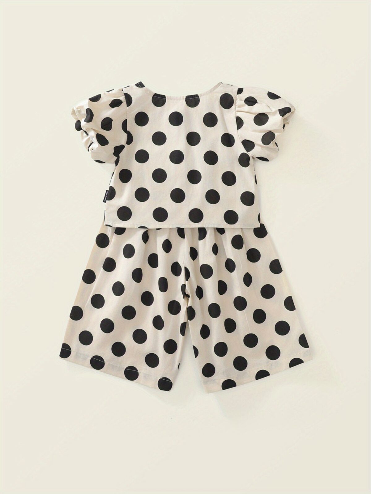 Adorable girls polka dot suit perfect for summer made from 100 soft cotton The suit features a mention specific details like sleeveless top and shorts or skirt design