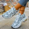 Newness Botanical Breeze Floral Slip On Sneakers White canvas sneakers adorned with a vibrant floral print showcasing breathable design and lightweight comfort