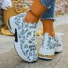 Newness Botanical Breeze Floral Slip On Sneakers White canvas sneakers adorned with a vibrant floral print showcasing breathable design and lightweight comfort