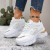 Newness City Chic White Lace Up Sneakers A pair of stylish white lace up sneakers with a modern design showcasing comfort and versatility
