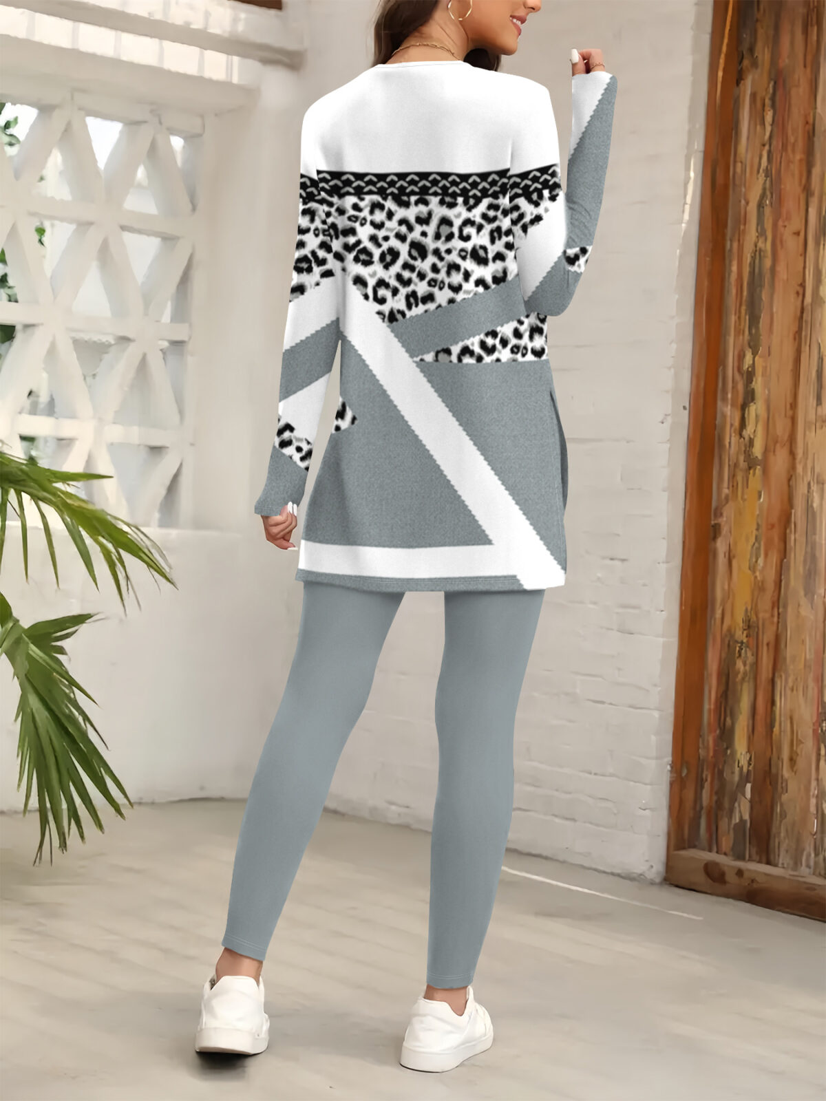 Stylish woman confidently posing in a chic leopard print pantsuit perfect for fall and winter The outfit features a flattering fit and luxurious fabric