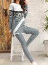 Stylish woman confidently posing in a chic leopard print pantsuit perfect for fall and winter The outfit features a flattering fit and luxurious fabric