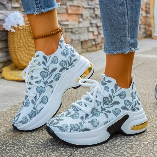 Newness Botanical Breeze Floral Slip On Sneakers White canvas sneakers adorned with a vibrant floral print showcasing breathable design and lightweight comfort