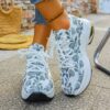 Newness Botanical Breeze Floral Slip On Sneakers White canvas sneakers adorned with a vibrant floral print showcasing breathable design and lightweight comfort