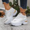 Newness City Chic White Lace Up Sneakers A pair of stylish white lace up sneakers with a modern design showcasing comfort and versatility