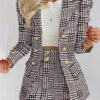 Model showcasing the Newness Kensington Plaid Skirt Set a chic and modern take on the classic plaid skirt set Featuring a stylishly tailored skirt and coordinating top