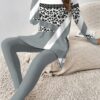 Stylish woman confidently posing in a chic leopard print pantsuit perfect for fall and winter The outfit features a flattering fit and luxurious fabric