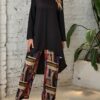 Model showcasing the Newness Casablanca Abstract Print Set a stylish two piece outfit with a solid color top and vibrant abstract print pants