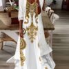 Stylish woman wearing the Newness Dubai Escape Paisley Vacation Dress Set posing against a backdrop of a luxurious Dubai hotel or resort The dress is a vibrant paisley print flowing elegantly