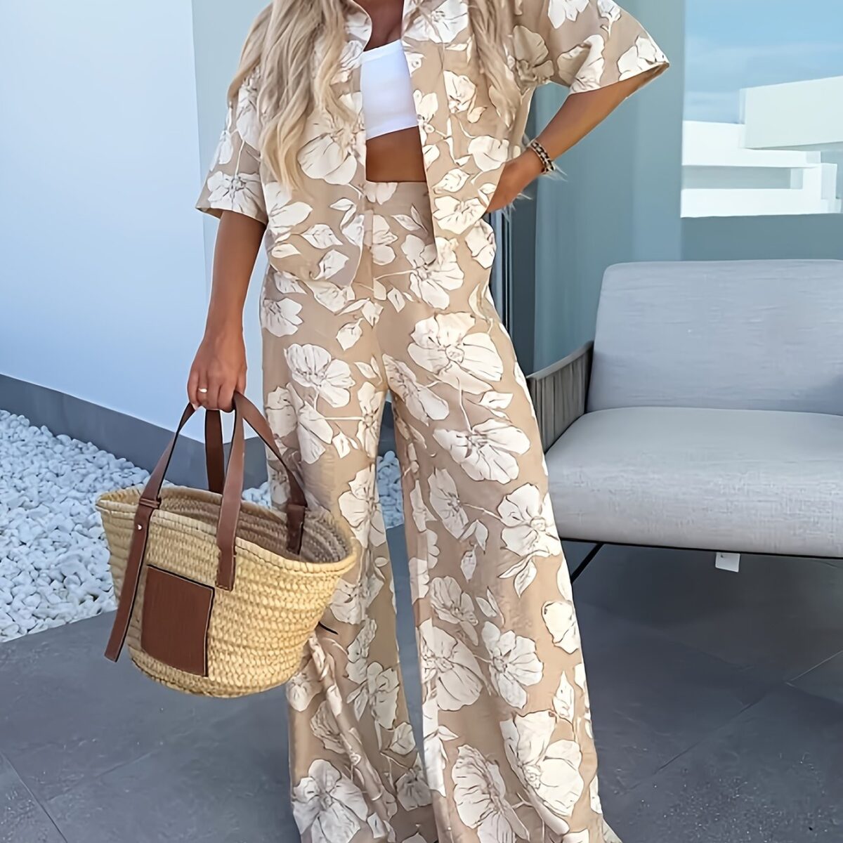 Stylish woman wearing the Newness Summer Breeze Floral Print Set posing outdoors in summery lighting The set includes a flowy top and coordinating shorts or skirt showcasing the beautiful floral print