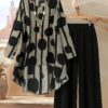 Model showcasing the Newness Nian Nian Printed Suit Set a sophisticated and effortlessly chic printed suit set perfect for any occasion
